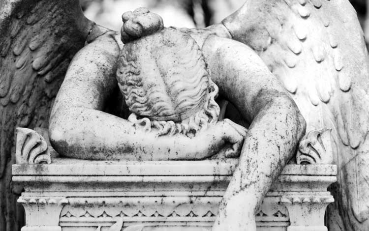 stone sculpture of angel fallen over